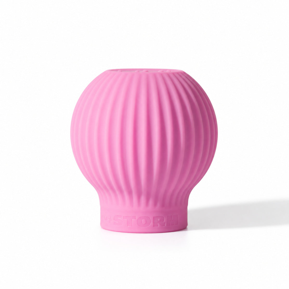 ByStorm Betty makeup grip in pink, a ribbed silicone ball with Braille on top, shaped to fill the palm for a fuller, steadier hold