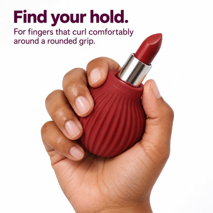 Hand curled around a maroon ByStorm Betty grip holding a lipstick. Text reads find your hold: for fingers that curl comfortably around a rounded grip