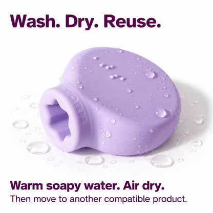 Lilac ByStorm Margie grip covered in water droplets, showing the star-shaped opening. Text reads wash, dry, reuse: warm soapy water, air dry, then move to another product