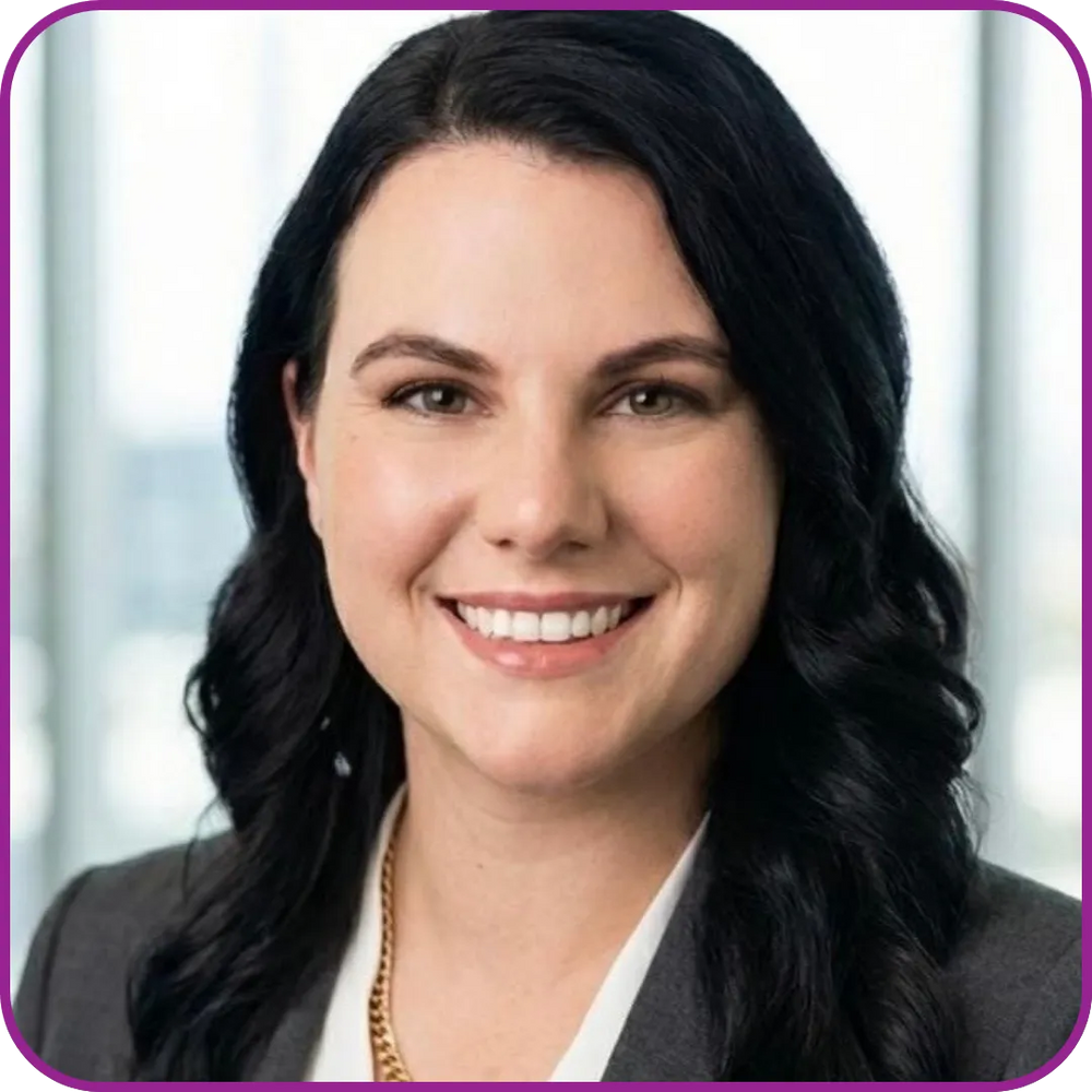 Woman with dark hair wearing a suit