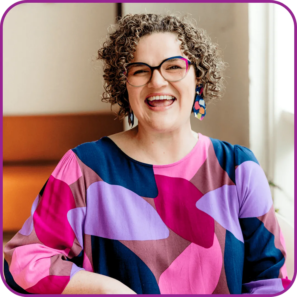 Person wearing a colorful patterned shirt with a blurred background