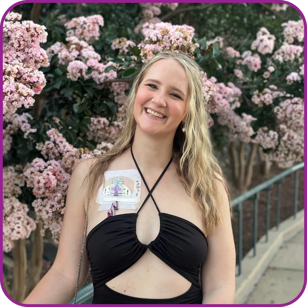 Woman in a black top with a floral background