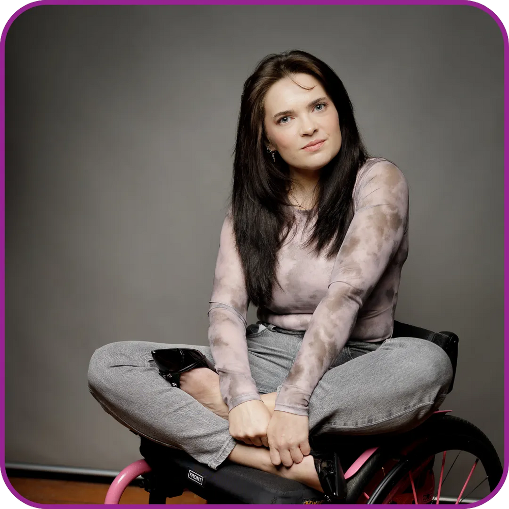 Woman sitting on a chair with a gray background