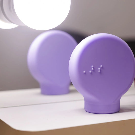 Close up of a Purple adaptive makeup grip, with visible braille dots, designed for easier handling and improved control during makeup application.