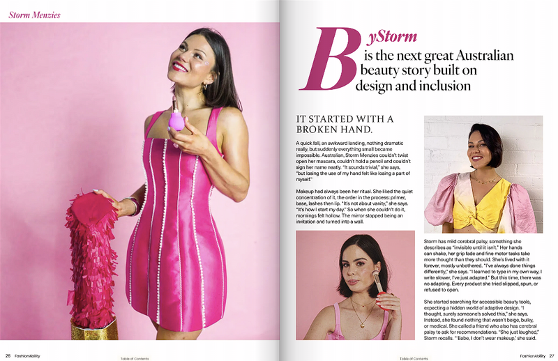 A magazine spread featuring a Storm Menzies in a vibrant pink dress, holding a matching pink item, smiling joyfully. The headline reads, "Bystorm is the next great Australian beauty story built on design and inclusion." Text narrates a personal story about beauty, design, and an inspiring journey. The page includes additional images of the woman in various poses, conveying confidence and happiness.