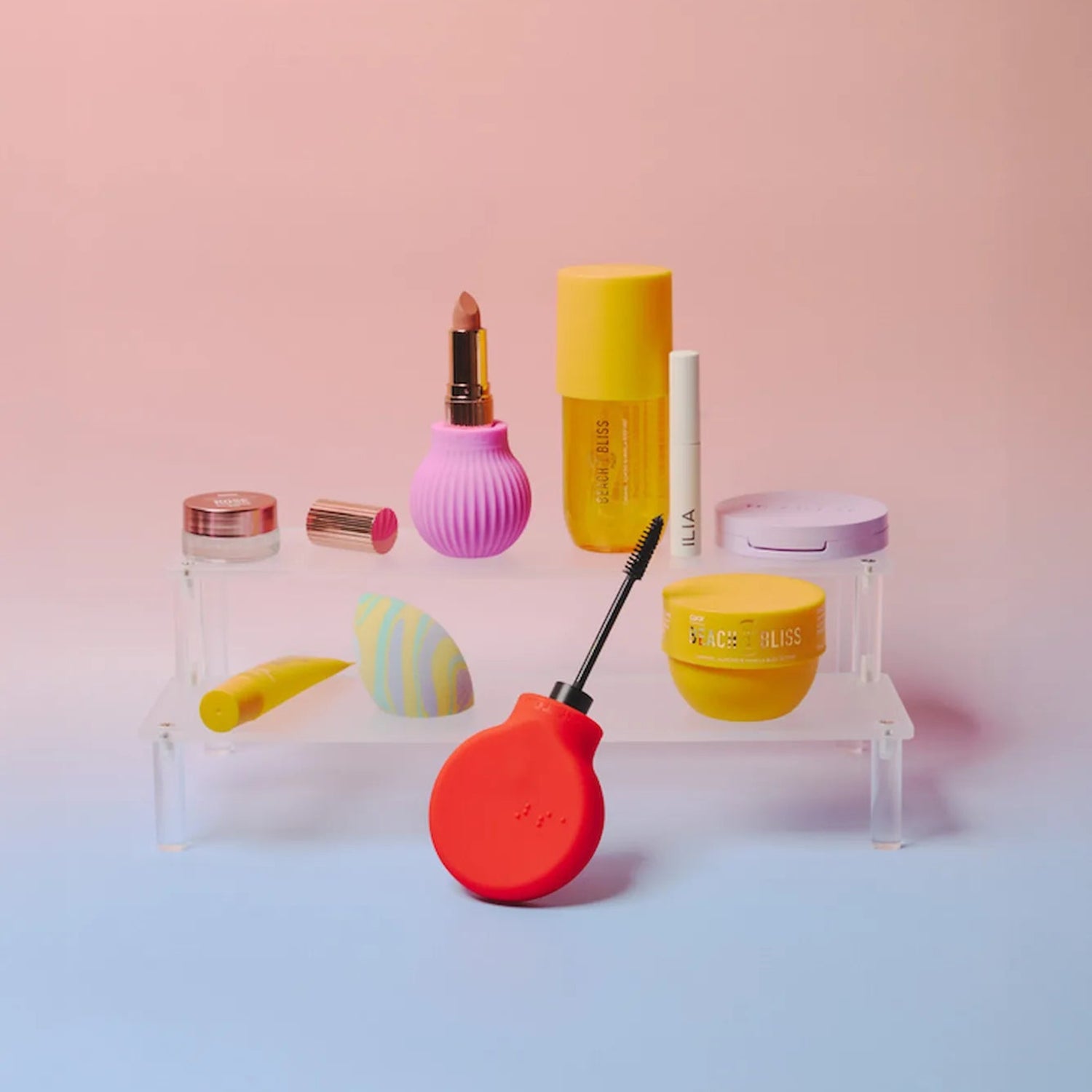  Cosmetics and ByStorm adaptive makeup grip tools with lipsticks and mascara on a stand