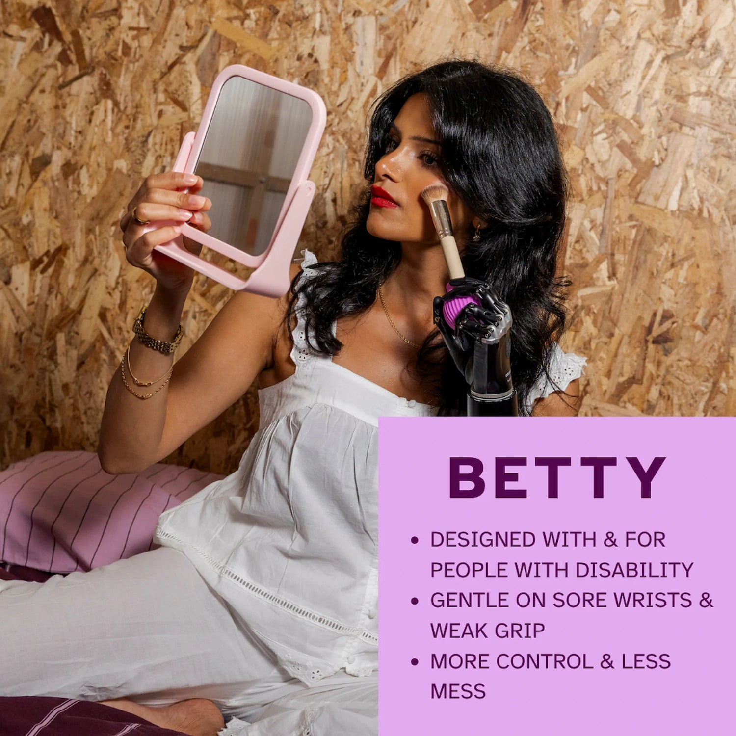 ByStorm Betty pink accessible makeup grip applying brush with prosthetic arm and mirror